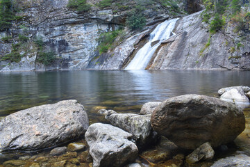 idyllic pond with a small waterfall in Kärnten, Austria called "Blauer Tumpf"