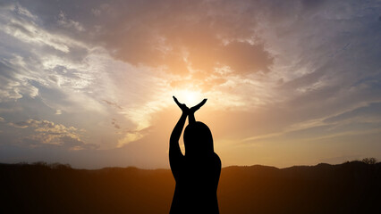 A woman raising her hand for a sacred blessing for peace and friendship to the world.