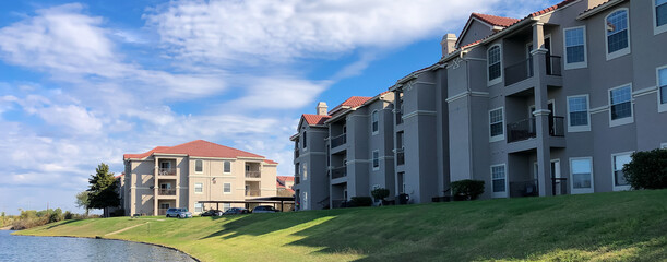 Panorama view waterfront apartment complex near retention pond in Lewisville, Texas, America