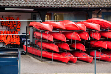 Storage of red kayaks and boats in hangar