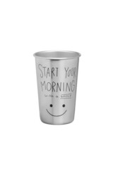 Subject shot of a matte metal glass with a saying 