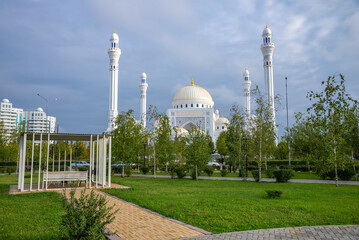 A park with a gazebo in front of a mosque in the city of Shali. Chechen Republic, Russia