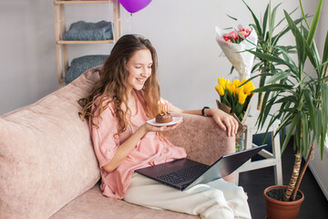 Happy young woman virtual meeting birthday party online  with laptop
