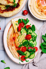 Hummus with fresh vegetable salad. top view .