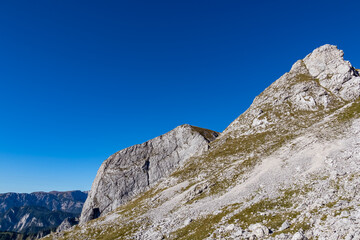 Fototapeta na wymiar Panoramic view on the mountain peaks of the Hochschwab Region in Upper Styria, Austria. Massiv sharp and high rock wall in the Alps in Europe. Climbing tourism, wilderness. Concept freedom. Limestone