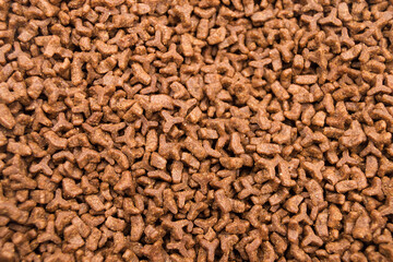 Dried cat food for animails as an abstract background brown texture