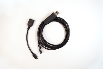 Usb cord of the endoscope rolled on a white background