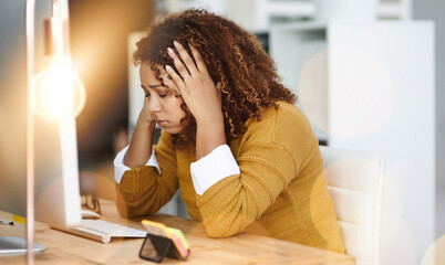 Ive got so much on my plate. Shot of a stressed young businesswoman sitting and working in the office at work.