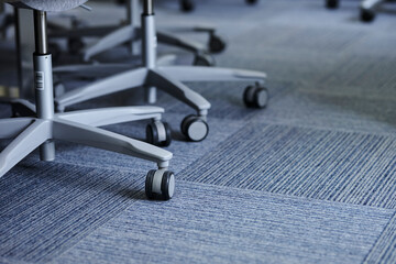 Gray office chair legs with wheels. gray plastic office chair legs with wheels on a gray carpet.