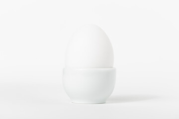 Egg in stand. All in white.
