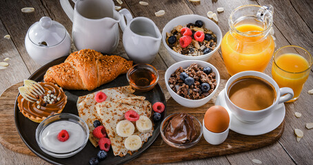 Breakfast served with coffee, juice, pancakes and croissants
