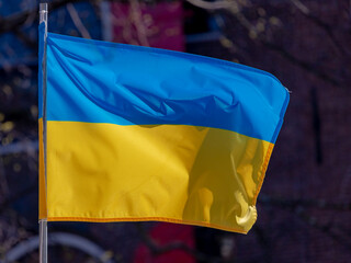 Stop the war, The national flag of Ukraine which has equally sized horizontal bands of blue and yellow, Ukraine flag hanging on the pole on the rooftop of house, Support Ukrainian from Russian attack.