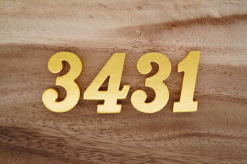 Golden Arabic numerals on a real brown and white wooden floor number 3431