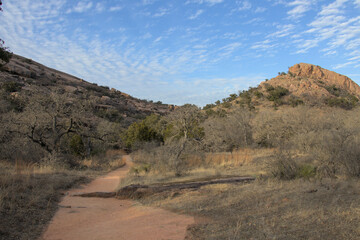 a dirt trail winding between two peaks