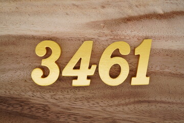 Golden Arabic numerals on a real brown and white wooden floor number 3461