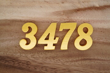 Golden Arabic numerals on a real brown and white wooden floor number 3478