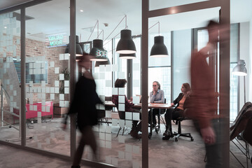 Obraz premium Successful team. Group of young multi-ethnic business people working and communicating together in creative office. Selective focus 