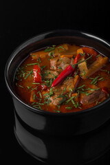 Sauce with potatoes and meat Ukrainian cooking. Photo of food on a dark background