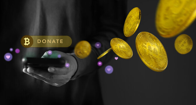 Online Donation by Cryptocurrency Concept. Closeup of Hand Using a Mobile Phone to making Donate Bitcoin via the Internet - Powered by Adobe