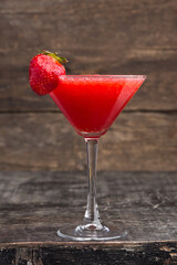 Alcoholic red strawberry drink in a glass, cocktail. Photography of drinks on a dark background
