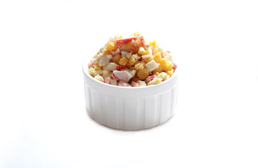 Salad with crab and corn in a white bowl on a white background