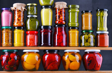 Jars with variety of pickled vegetables and fruits