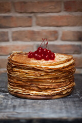 Sweet dessert pancakes with viburnum. Photo of food on a dark background