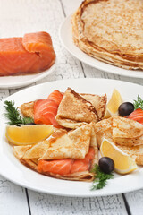 Pancakes with red fish. Photo of food on a light background