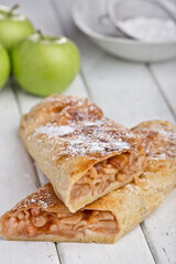 Baked strudel with apple. Photo of food on a light background