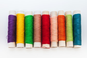 threads on spools on white background