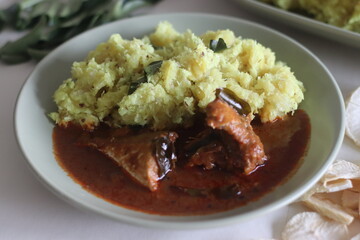 Mashed dry casava or dry tapioca with grated coconut, shallots, chillies, turmeric and curry...