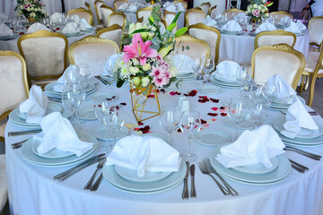Arrangement of an elegant wedding party table in a special events ballroom.