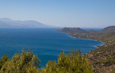Fototapeta na wymiar Beautiful seascape, coastline with blue Mediterranean Sea and green trees from top view, Greece