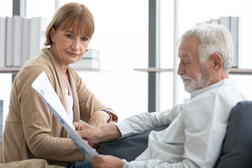 senior couple reading a newspaper in free time