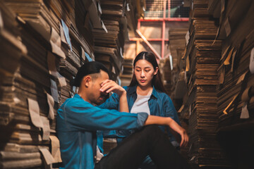 Asian Business owner sitting in factory plantation posing feel tried and serious with work.Engineer or Factory worker  hard work.Unemployed Feeling Stressed.