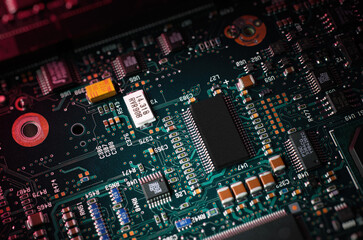 Green circuit board with microchip. Military industry electronics. Hi-tech device of military purpose. Heavy duty computer. Semiconductor component