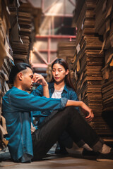 Asian Business owner sitting in factory plantation posing feel tried and serious with work.Engineer or Factory worker  hard work.Unemployed Feeling Stressed.