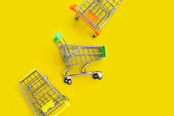 Shopping trolley or Shopping cart on yellow background.