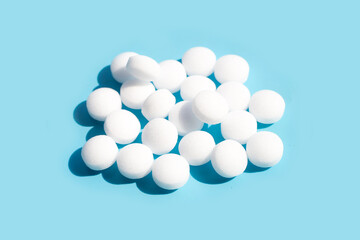 Naphthalene mothballs on blue backgrond.