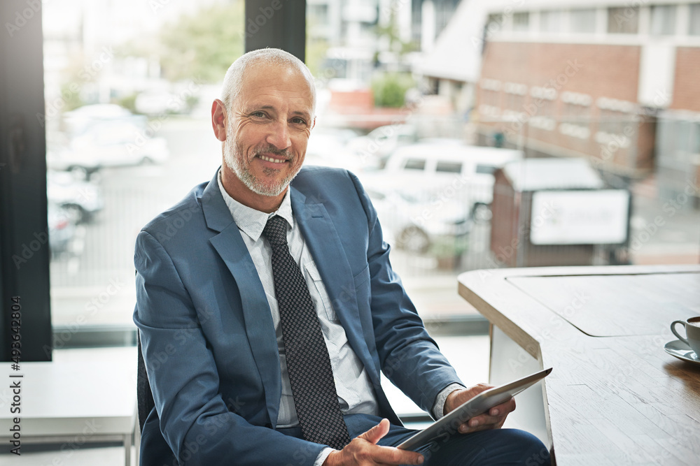 Aufkleber moving forward with the help of technology. portrait of a mature businessman working on a digital ta