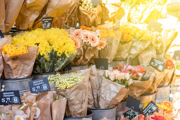 Flower business. Flowers are white in kraft paper standing on the counter. German words: summer chrysanthemum, Words in German: summer chrysanthemum, paradise daffodils, freshness 7 days guaranteed