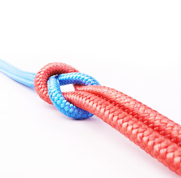 Its A Strong Bond. Studio Shot Two Ropes Knotted Together Isolated On White.