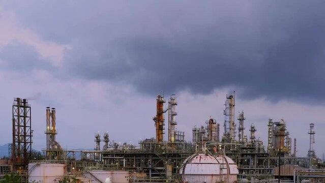 Time lapse of Oil and gas refinery plant or petrochemical industry, Gas storage sphere tank and distillation tower in petroleum industrial