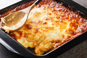 Portuguese casserole Bacalhau espiritual or Spiritual cod closeup in the baking dish. Horizontal