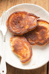 Pancakes with apples, cinnamon and icing sugar 