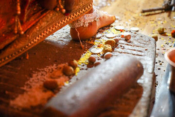 Newly wed Indian bride entering new house a rituals.
