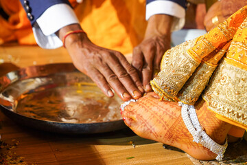 Indian Hindu wedding rituals father in law offering blessing to bride.