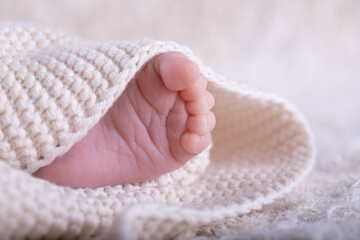 New Born Baby Feet on White Blanket