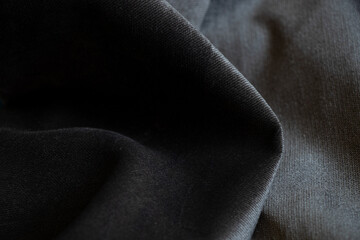 Gray black wrinkled velor fabric as background closeup, fashion and trends, gray