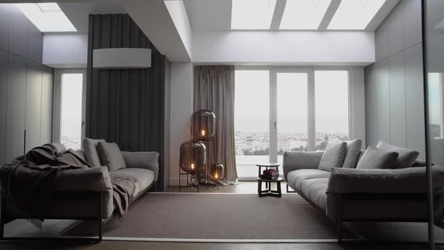 Real Modern Apartment with Living Room and comfortable Furniture, modern lamp and large windows. Fashionable furniture store. Comfort sofa in empty room with nobody inside at house. 